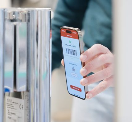 Customer uses a smartphone to scan a barcode at the exit gate.