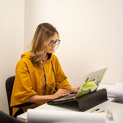 Giulia works with her laptop